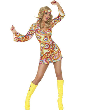 Image of woman wearing colourful printed mini dress with matching bandana and yellow gogo boots.