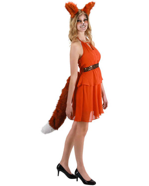 Image of girl wearing orange dress and large orange fox tail.